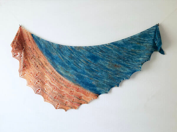 Koi in the Pond - A knit shawl in turquoise, orange, and variegated yarn. Shown flat against a white background.