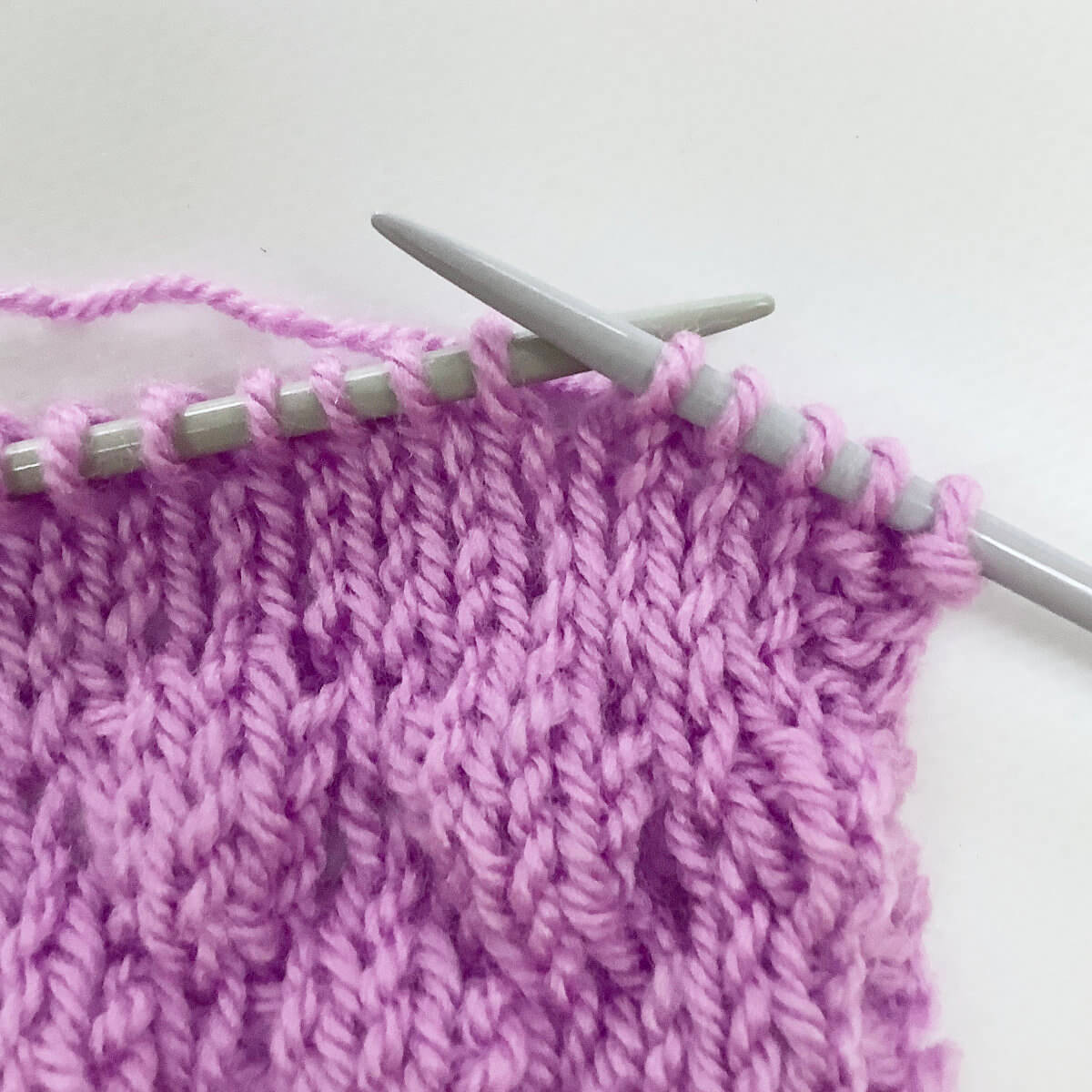 Step 1 of working the knit 4 below (k4b) stitch