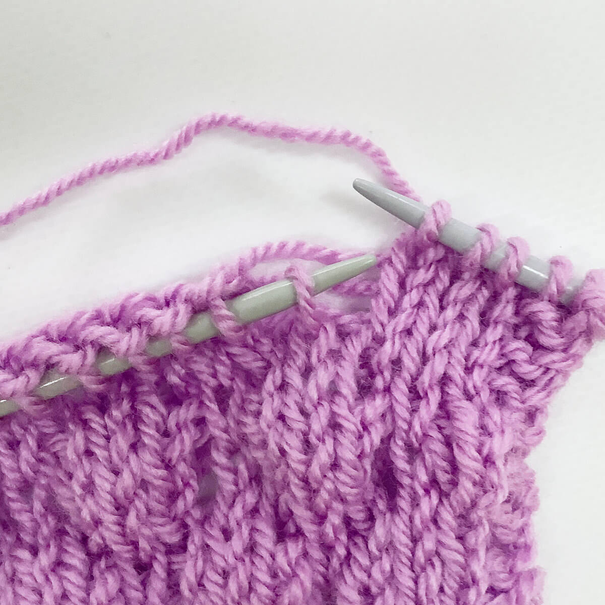 Step 3 of working the knit 4 below (k4b) stitch