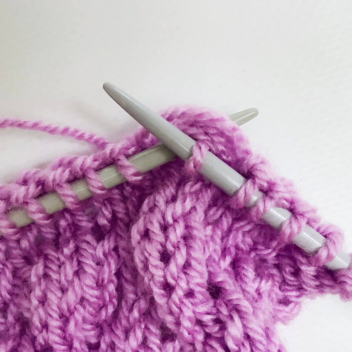 Step 7 of working the knit 4 below (k4b) stitch